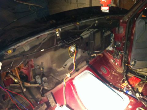 1996 Ford Bronco - The interior of a 1996 Ford Bronco is shown disassembled, revealing exposed wiring and components.
