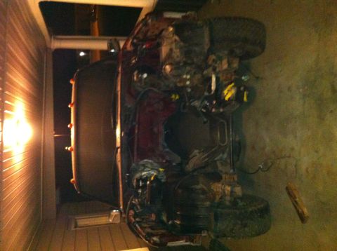 1996 Ford Bronco - This 1996 Ford Bronco is overturned, showing its undercarriage and engine components.