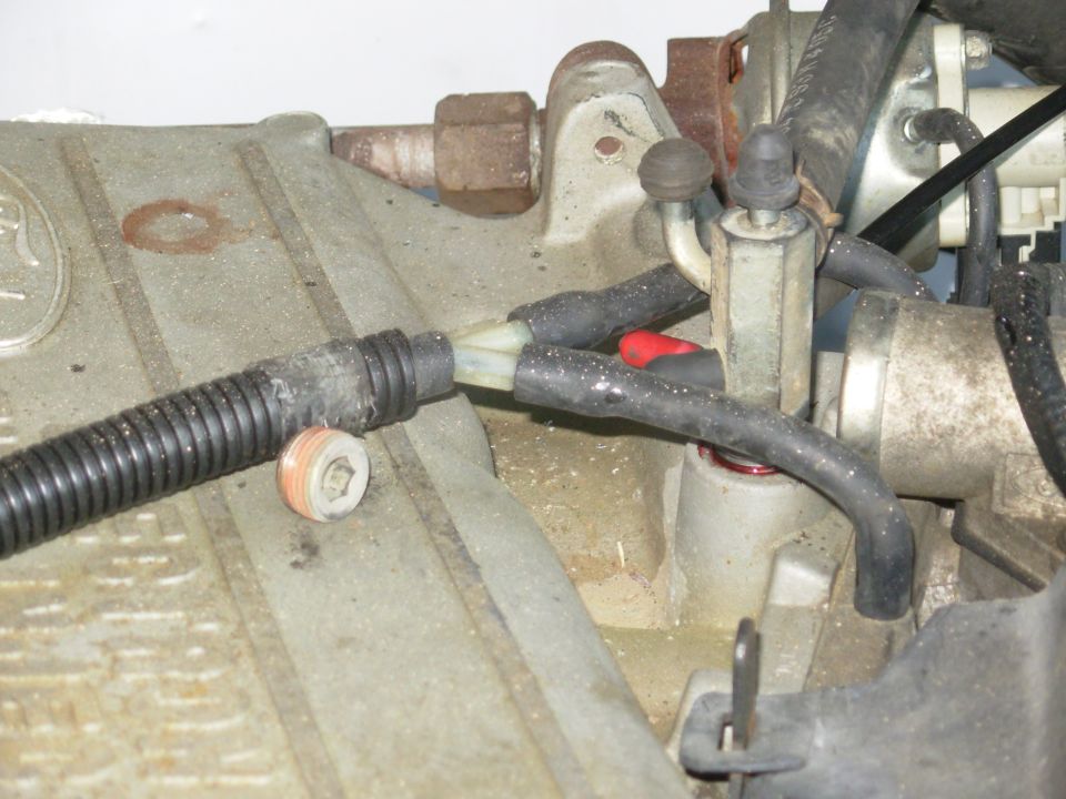 I plan to have a vacuum gauge on the dash, so I needed another port on the vacuum tree, but they were all in use.  So I removed the factory plug from this location & installed another tree from a JY engine, capped the nipples I don't need right now, and shortened the brake booster line to fit here.

[url=http://www.amazon.com/dp/B001Q5GPAM/]Au-Ve-Co 12209[/url] Vacuum Cap 1/8" (25pcs/box)
Au-Ve-Co 4440 Vacuum Cap 3/16" (25pcs/box)
