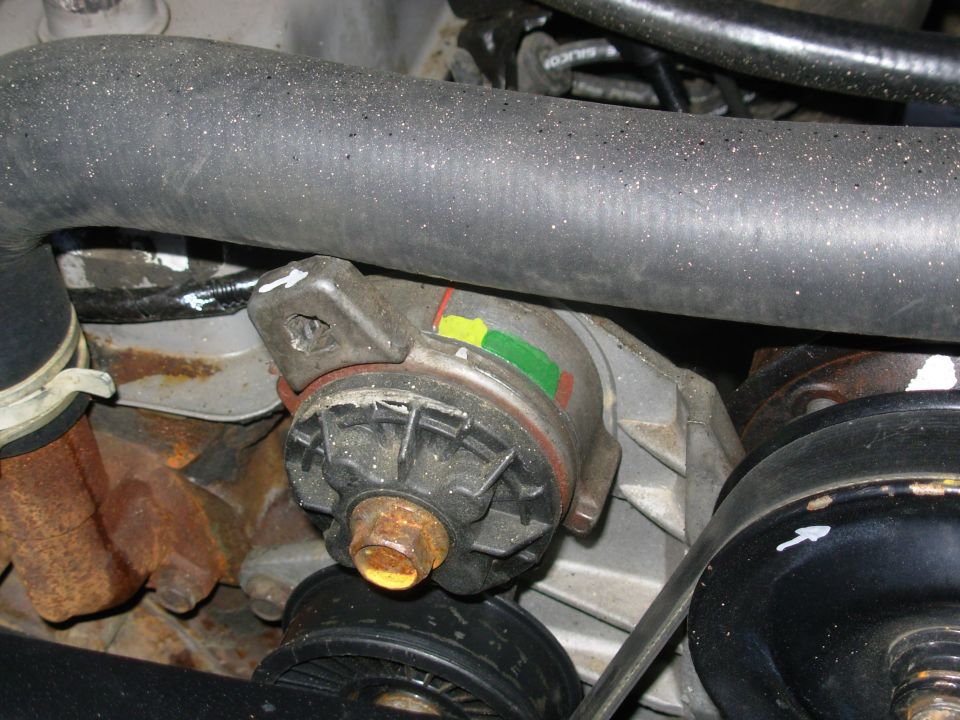 The old compressor I was using temporarily (just so the belt would stay on) had a ~5" pulley, but the correct compressor's pulley is nearly 6", so that belt doesn't fit now.  This is the '93 5.8L belt (K61020), and it's just slightly too long, but it'll certainly work for a while.  I guess I need a K61010 or K61005.

UPDATE:  About 2.5 years after this pic, the tensioner boss rubbed through the radiator hose.  So I ground down that top rear corner before installing the replacement hose.