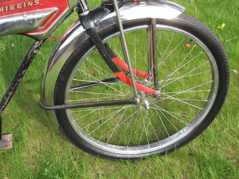 1994 Ford Bronco - Front wheel and fender of a red and chrome bicycle, with the brand name 'HIGGINS' visible on the frame.