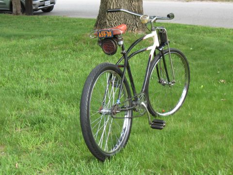 1994 Ford Bronco - A custom bicycle with a brown seat and a license plate is parked on a grassy lawn.