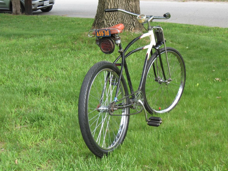 Custom bicycle with brown seat and license plate A59-30, seen from rear