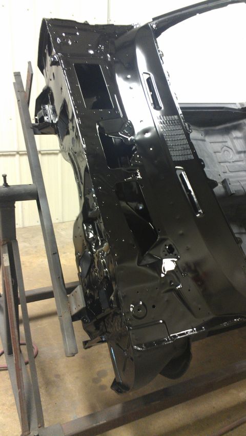 1972 Pontiac Trans Am - The black painted firewall and dashboard structure of a car is shown, mounted on a stand for work.