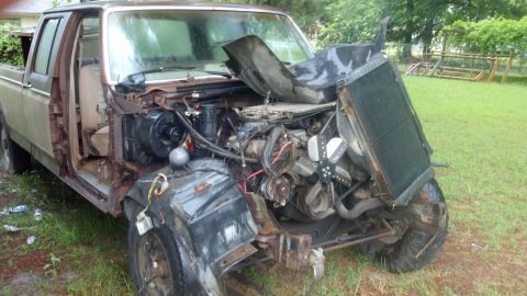 1983 Ford F-250 - This heavily damaged pickup truck shows its engine and radiator after a significant front-end collision.