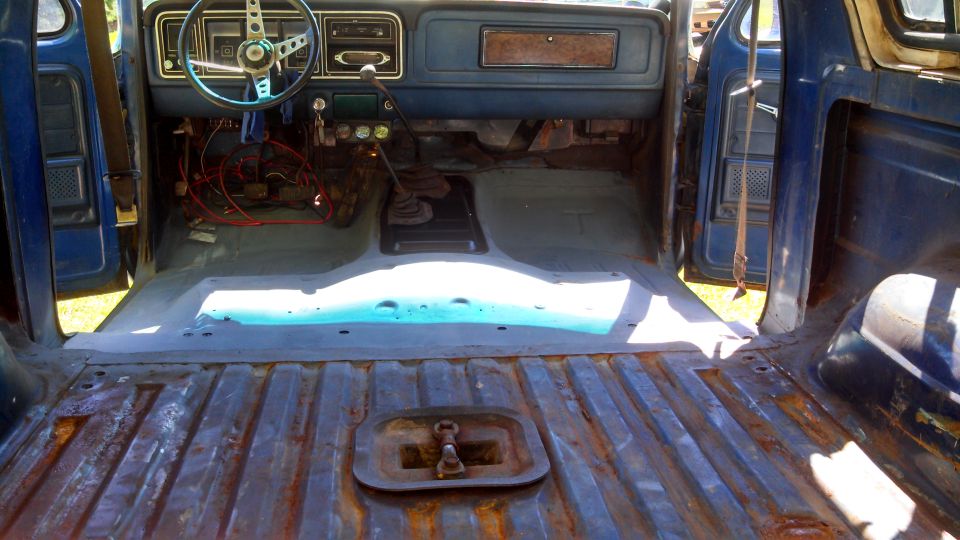 1979 Ford Bronco interior showing dashboard, steering wheel, and empty floor