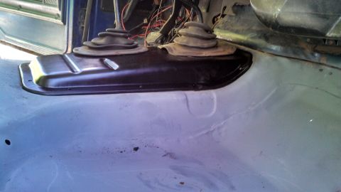 1979 Ford Bronco - The interior floor and transmission tunnel are visible, dual shifters and exposed wiring.