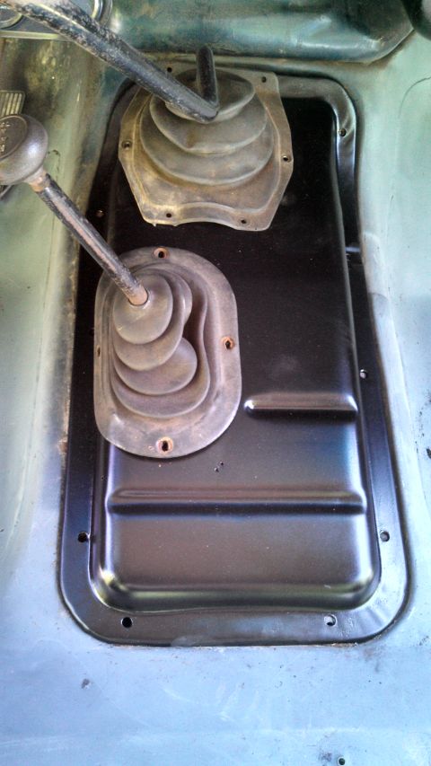 1979 Ford Bronco - Close-up of the floor console area showing the manual transmission shifter and transfer case shifter boots.