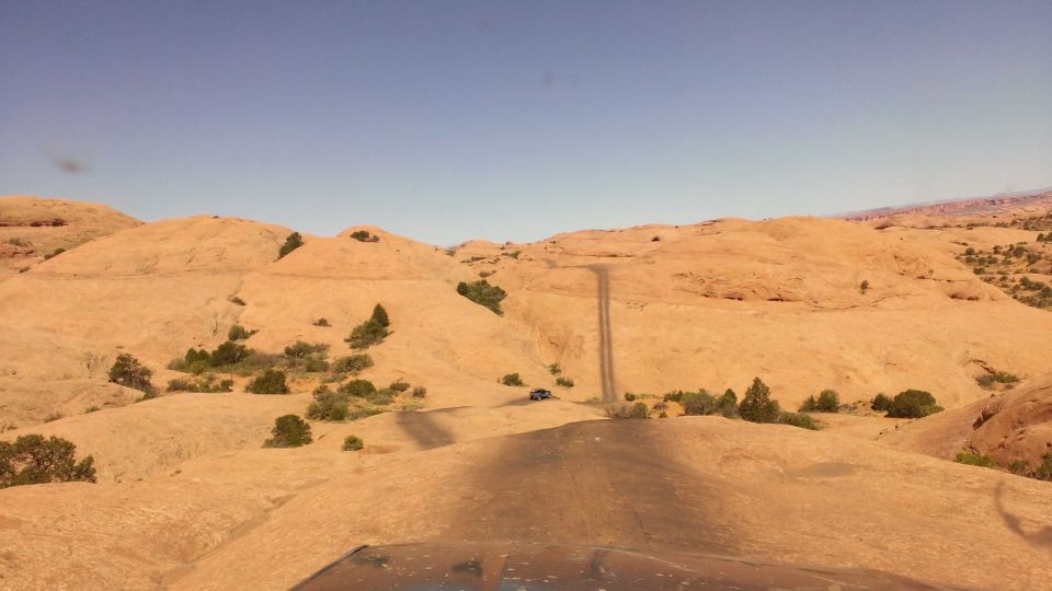 Dark SUV on desert road