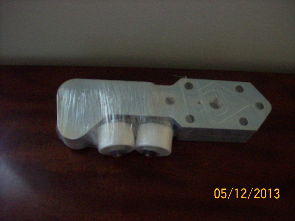Engine part wrapped in plastic with two cylindrical components visible