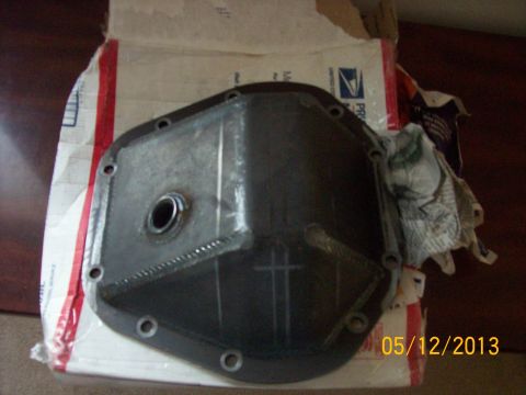 1982 Ford F-100 - Differential cover shown on a cardboard box, with a rag to the side.