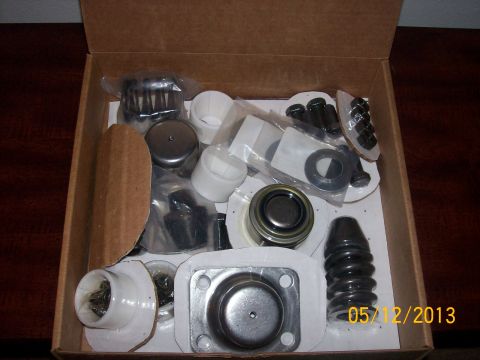 1982 Ford F-100 - A collection of new vehicle parts are neatly arranged inside a cardboard box, ready for installation.