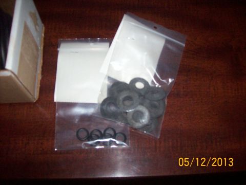1982 Ford F-100 - Several small, circular rubber parts are displayed in plastic bags next to a cardboard box.