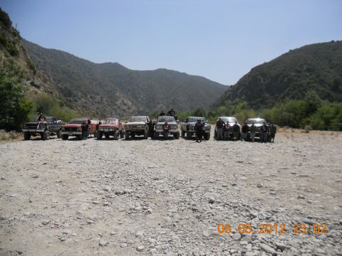 1986 Ford Bronco - A convoy of off-road vehicles is gathered in a scenic, outdoor location.
