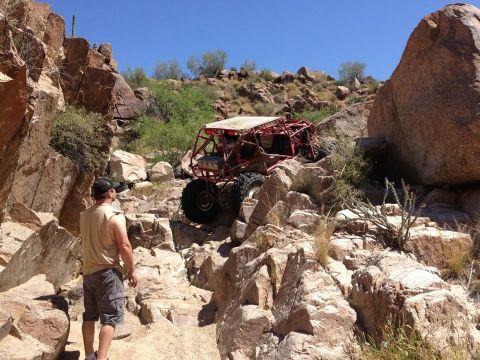 1966 Ford Bronco - This custom buggy is tackling a challenging rocky trail in a desert environment.
