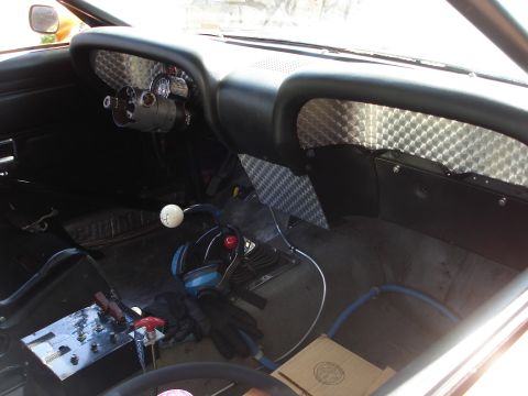 1970 Ford Mustang - The interior of a modified 1970 Ford Mustang shows racing enhancements and custom dashboard elements.