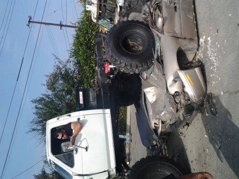 1986 Ford Bronco - Two vehicles involved in a collision are shown on the side of the road, with debris scattered around.