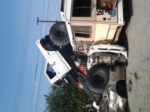 1986 Ford Bronco - Multiple vehicles involved in a collision, with one truck on top of a car.