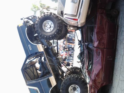 1986 Ford Bronco - Multiple vehicles are involved in a collision, with an off-road truck dominating the scene.