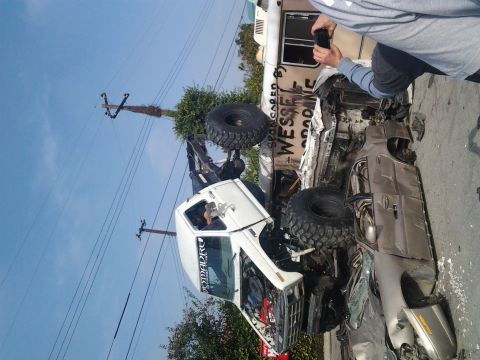 1986 Ford Bronco - Multiple off-road vehicles sustained significant damage in what appears to be a collision or rollover incident.