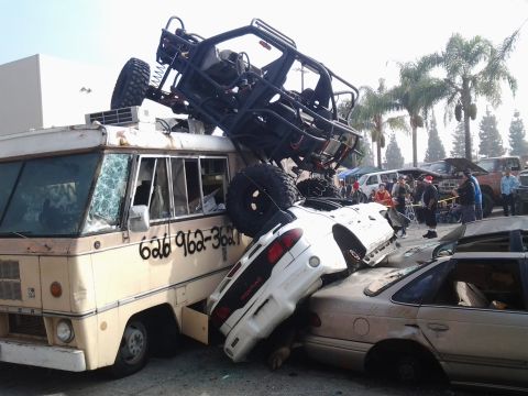 1986 Ford Bronco - Multiple vehicles are severely damaged and piled up in a chaotic scene.