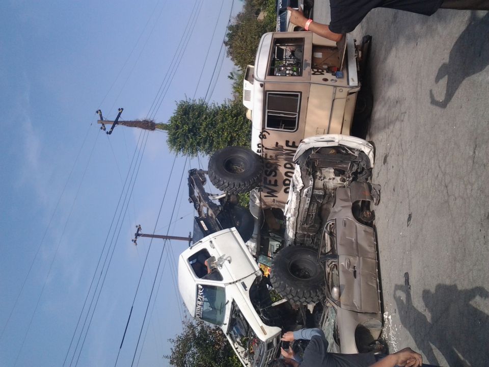 Two off-road trucks piled up, one with a camper top and "WESSEL PROPANE" text