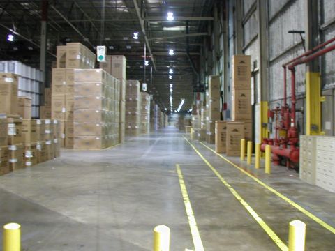 1998 Ford Taurus - This is a view down a long warehouse aisle, filled with boxes and industrial equipment.