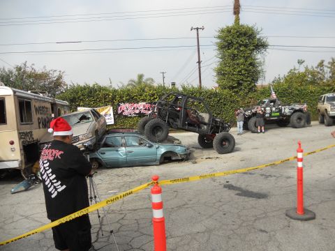1986 Ford Bronco - A scene with multiple vehicles, including a buggy on top of wrecked cars, and a modified truck.