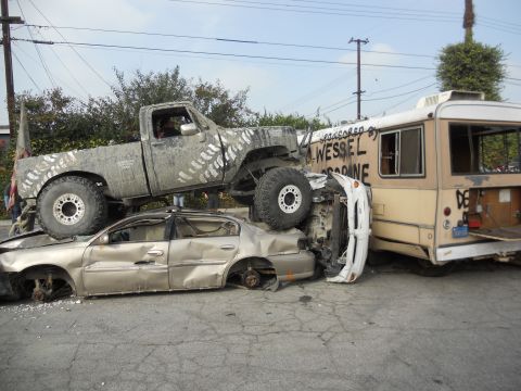 1986 Ford Bronco - A chaotic scene with multiple vehicles involved in what appears to be a destructive event.
