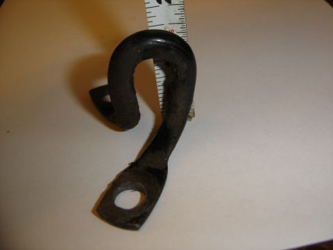 1996 Ford Bronco - A black metal torsion bar loop bracket is shown with a ruler for scale.