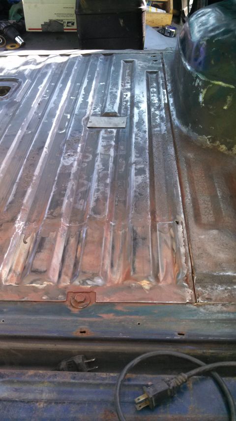 1979 Ford Bronco - The ribbed metal floor of a truck bed shows signs of rust and wear.