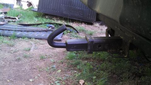 1979 Ford Bronco - Close-up of a trailer hitch on a vehicle, with a bent hook extension visible.