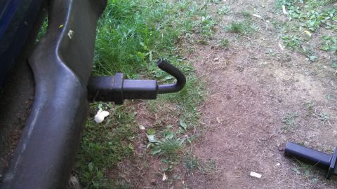 1979 Ford Bronco - Close-up view of a vehicle's exhaust pipe and trailer hitch assembly.