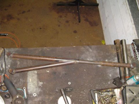1993 Ford Bronco - A custom-fabricated antiwrap bar, likely for off-road use, is shown on a workbench with various tools and parts.