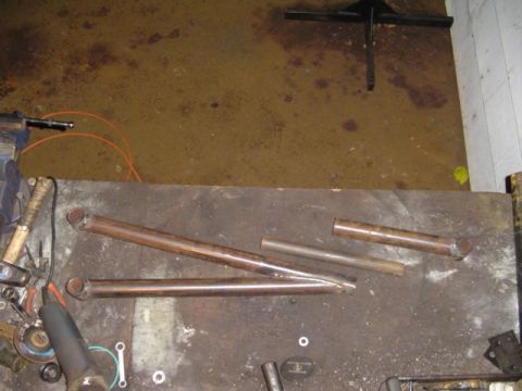 1993 Ford Bronco - Metal tubes and tools are laid out on a workbench, possibly for fabrication or repair.