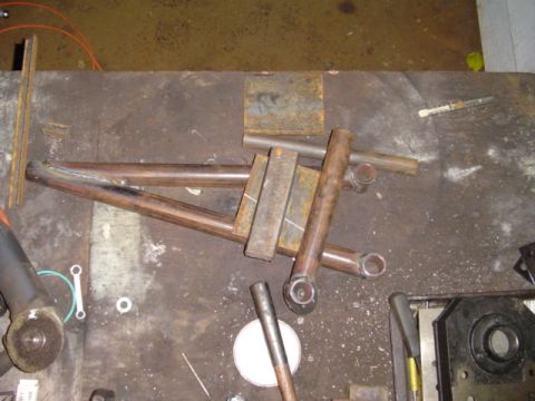 1993 Ford Bronco - Metal parts are laid out on a workbench, ready for fabrication or assembly.
