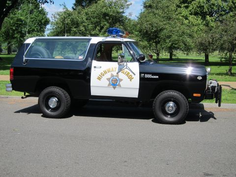 1991 Ford LTD Crown Victoria - Side view of a black-and-white Dodge Ramcharger marked California Highway Patrol, parked on a grassy roadside with a roof light bar.