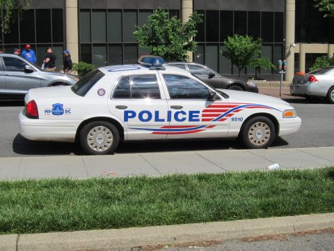 1991 Ford LTD Crown Victoria - white Ford Crown Victoria police cruiser marked POLICE 9510 photographed in profile along an urban curb.