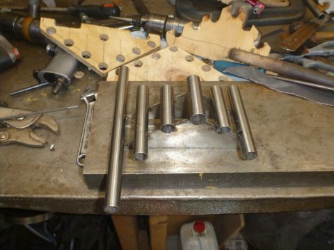 1964 Mercury Monterey - Various metal tubes and tools are laid out on a workbench, suggesting a fabrication or repair project.
