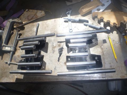 1964 Mercury Monterey - Metal exhaust pipes are clamped to a workbench, ready for installation or modification.