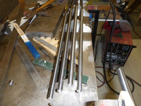 1964 Mercury Monterey - Workbench setup with metal pipes, a welder, and various tools for fabrication.
