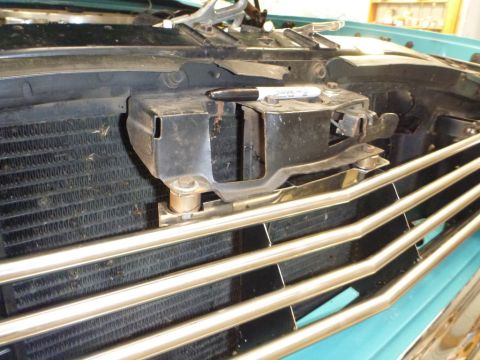 1964 Mercury Monterey - Close-up of the front grille and radiator of a 1964 Mercury Monterey, with a marker pen resting on the latch assembly.