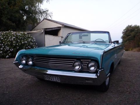 1964 Mercury Monterey - Turquoise 1964 Mercury Monterey convertible parked in front of a house.