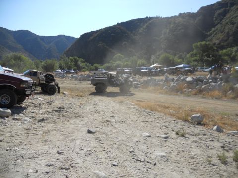 1986 Ford Bronco - A gathering of off-road vehicles in a scenic, mountainous terrain.