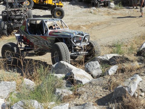 1986 Ford Bronco - A custom-built buggy with a roll cage tackles a challenging rocky obstacle course.