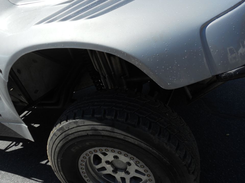 White off-road vehicle fender and tire with custom wheels