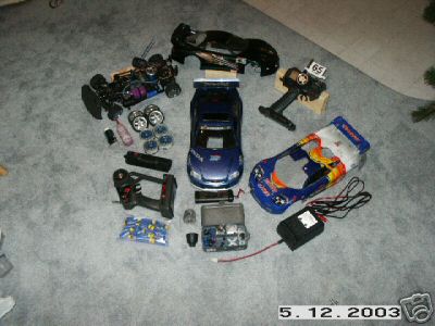 1998 Mercury Sable - Various radio-controlled car components are laid out on a carpeted surface.