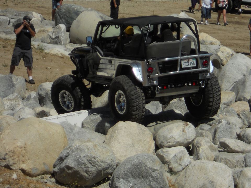 Modified Jeep Wrangler navigating rocks, rear view