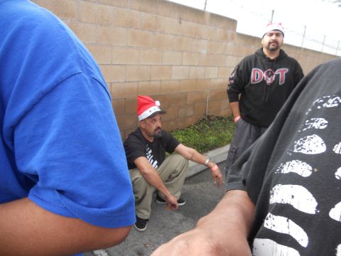 1986 Ford Bronco - Men in Santa hats gather near a brick wall, possibly at an outdoor event.