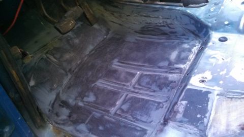1979 Ford Bronco - The interior floor of a vehicle, showing pedals and what looks like bodywork in progress.